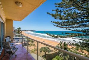 a balcony with a view of the beach at Beachfront Dream - Direct Beachfront in Narrabeen