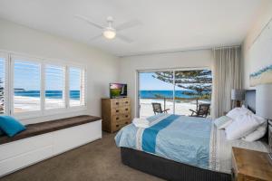 a bedroom with a bed and a view of the ocean at Beachfront Dream - Direct Beachfront in Narrabeen