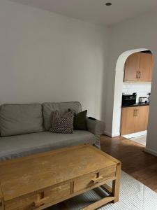 a living room with a couch and a coffee table at Rickmansworth Lodge in Watford