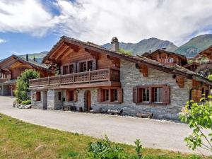 a large stone house with a balcony on top of it at 5 bedroom luxury Chalet by Dieckereise in Verbier