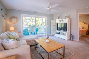 a living room with a couch and a tv at Condo in St James in Southport - Great amenities in Southport