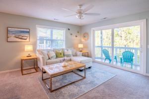 a living room with a couch and a table at Condo in St James in Southport - Great amenities in Southport
