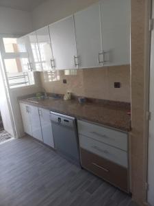 a kitchen with white cabinets and a counter top at RABATCENTRALRESIDENCE in Rabat