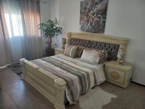 a bedroom with a large bed with pillows on it at RABATCENTRALRESIDENCE in Rabat