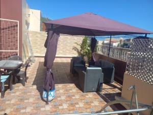 a purple umbrella on top of a balcony at RABATCENTRALRESIDENCE in Rabat