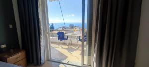 a view from a window of a patio with a table and chairs at Ionian View in Gjilek