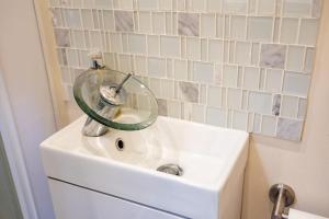 a bathroom sink with a glass stopper on top of it at Cosy countryside retreat, Weiser in Buckinghamshire