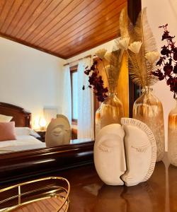 a bedroom with a bed and vases on a table at Finca León in Santa Brígida