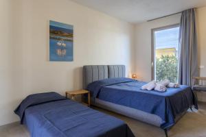 a bedroom with two beds and a window at Gl holiday home in Marsala