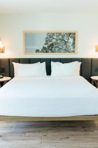 a large bed with white sheets and pillows at Sea Palms Resort in Saint Simons Island