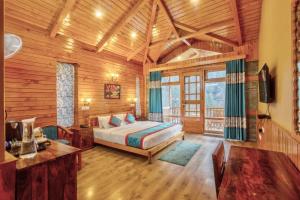 a bedroom with a bed in a room with wooden walls at The Blue Stream Cottage in Jibhi