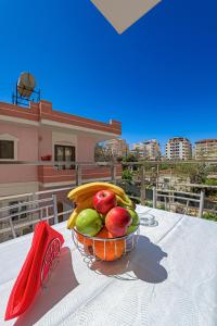 a basket of fruit on a table on a balcony at Valentina Apartment 1 in Sarandë