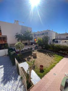 a view of a courtyard with trees and buildings at LA CASITA GALEON in Torrevieja