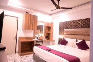a bedroom with a bed and a desk in it at HOTEL ALL SEASON in Havelock Island