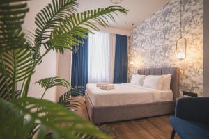 a hotel room with a bed and a plant at Downtown Suites by Athens Tower Hotel in Athens