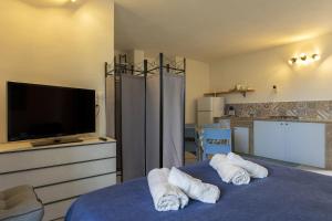 a bedroom with a blue bed with towels on it at Gl holiday home in Marsala