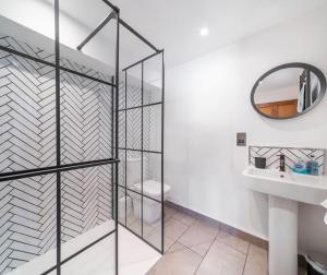 a bathroom with a glass shower stall and a sink at Old Dairy Cottage - Cosy and Luxurious! in Buckinghamshire
