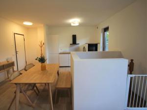 a living room with a table and a kitchen at Apartment Haridian by Interhome in Porto Valtravaglia