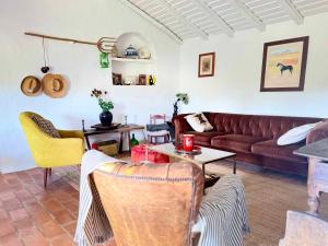 a living room with a couch and a table at The Stream House - Montes da Ronha in Zambujeira do Mar