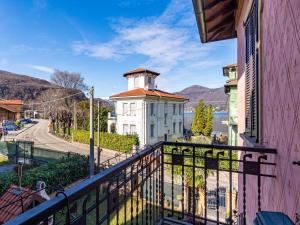 a balcony with a white building with a tower at Holiday Home Valentina by Interhome in Porto Ceresio