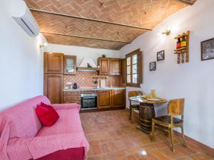 a living room with a couch and a table at Holiday Home Villino PERO by Interhome in Montescudaio