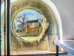 a circular window with a view of a building at Holiday Home Villino PERO by Interhome in Montescudaio