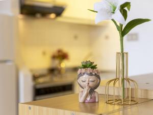 a figurine sitting on a counter with a flower in a vase at Apartment 0-5-F - Marineledda by Interhome in Golfo Aranci