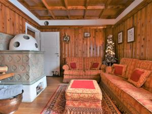 a living room with a couch and a fireplace at Chalet Chalet Franca by Interhome in Madesimo