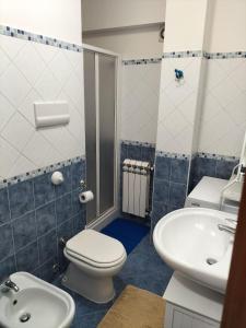 a bathroom with a toilet and a sink at Turi house in Messina +14 photos