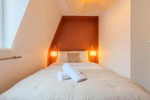 a bedroom with a bed with two pillows on it at 1 bedroom courtyard house typical of Old Lille in Lille