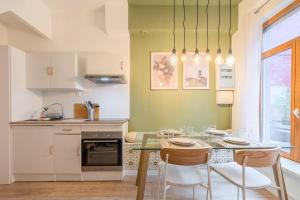 a kitchen with a glass table and chairs in a kitchen at 1 bedroom courtyard house typical of Old Lille in Lille