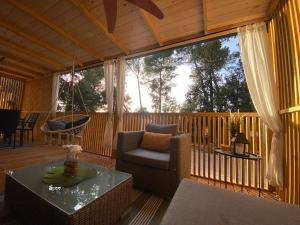 a screened in porch with a chair and a table at Summer Stay - Mobile Home in Biograd na Moru
