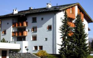 a white building with balconies on the side of it at Maurus A3 in St. Moritz