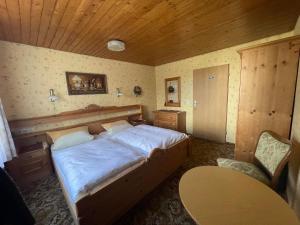 a bedroom with a large bed with a wooden ceiling at Haus Rosa in Sankt Johann
