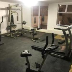 a room with a gym with several exercising machines at Studio Zen in Cape Town