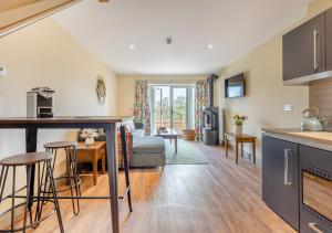 a kitchen and living room with a couch and a table at The Pear Tree - Pershore in Pershore