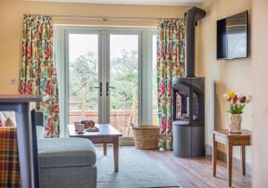 a living room with a fireplace and a window at The Pear Tree - Pershore in Pershore
