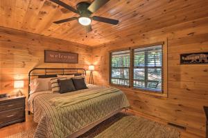 a bedroom with a bed and a ceiling fan at Blue Ridge Cabin Hot Tub, Fire Pit and Grill! in Blue Ridge