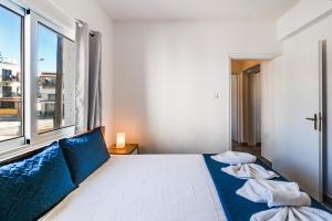 een slaapkamer met een bed en een groot raam bij Ayia Napa Central Apartment by Ezoria Villas in Ayia Napa