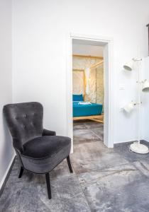 a black chair in a room with a bedroom at Ferienhaus für 4 Personen ca 79 m in Faliraki, Ägäis Rhodos in Faliraki