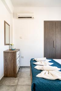 Ayia Napa Central Apartment by Ezoria Villas في أيا نابا: غرفة نوم بسريرين عليها وسائد بيضاء
