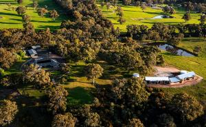 an aerial view of a house on a hill with trees at Benbullen Retreat in Angaston
