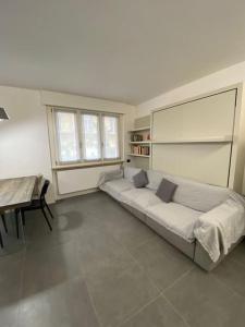 a bedroom with a bed and a table in it at Modern apartment on the beach in Nago-Torbole