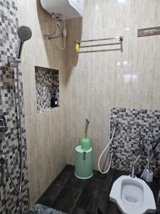 a bathroom with a shower and a toilet in it at Omah Tabon Jogja - Dekat Dengan Malioboro in Timuran