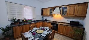 a kitchen with a table with chairs and a stove at The Palm Villa in St Paul's Bay