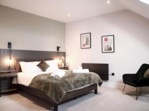a bedroom with a bed and a desk and a chair at Apartment 1 Old Conservative Club in Historic Town Pass the Keys in Caernarfon