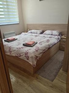 a bedroom with a bed with two pillows on it at Gondola 121 in Zlatibor +10 photos