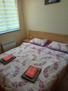 a bedroom with a bed with two pillows on it at Gondola 121 in Zlatibor