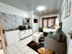 a small room with a bed and a couch in it at Contemporary Gem: Studio with Serene Pool View in Newcastle
