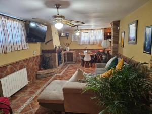 a living room with a couch and a dining room at Apto-en el Bajo de la casa-estilo rústico en Dílar in Dílar